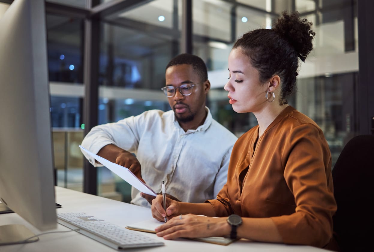 colleagues reviewing a document at a desk