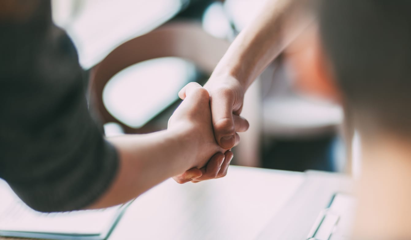 close up of a business handshake in an office